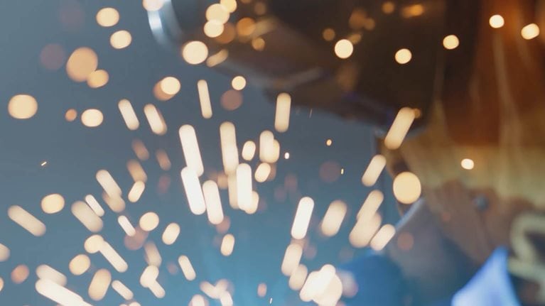 Sparks flying in close up of welding