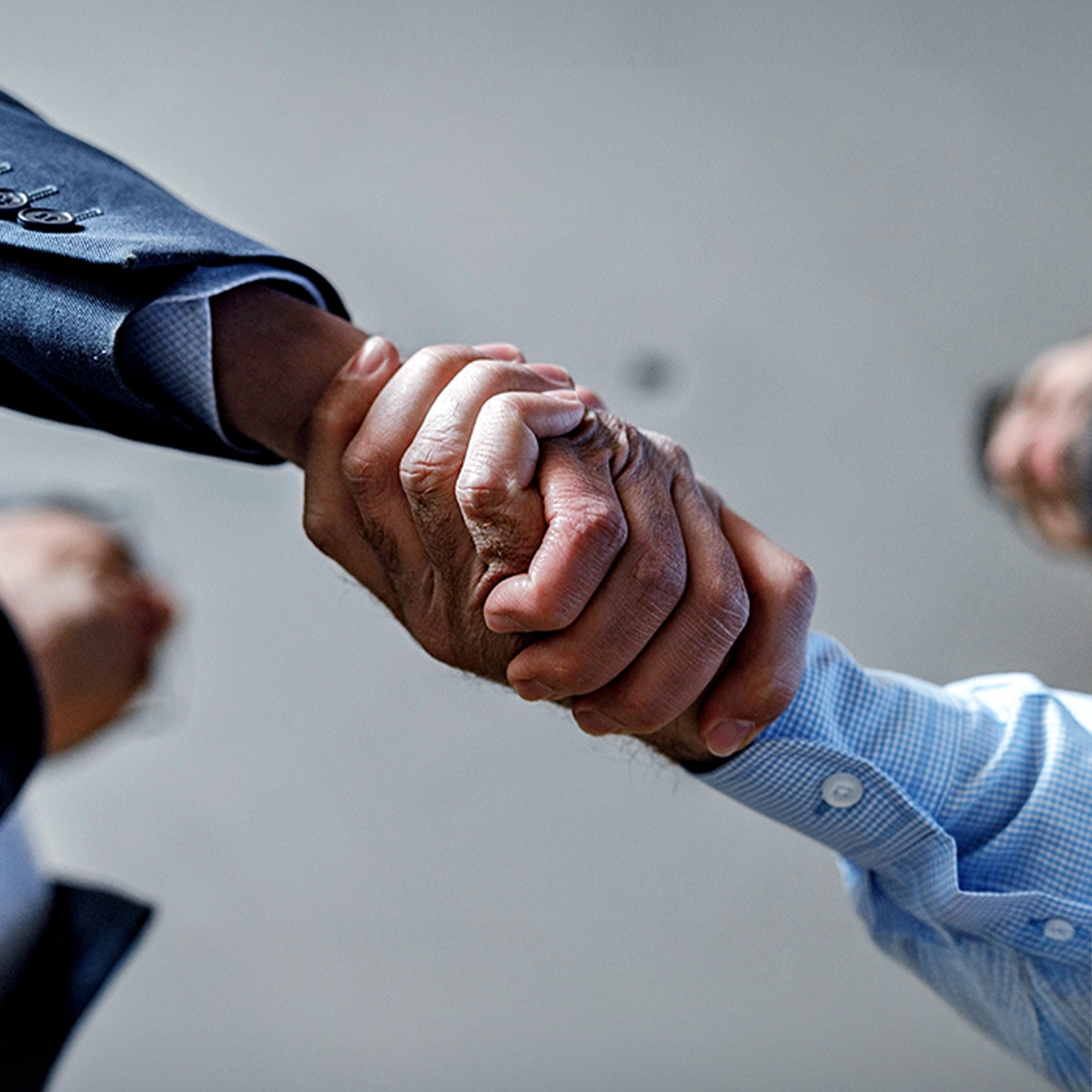 Close up of two businessmen shaking hands.