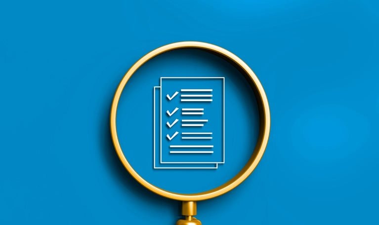 A gold magnifying glass with a checklist inside its lens, all against a solid blue background.