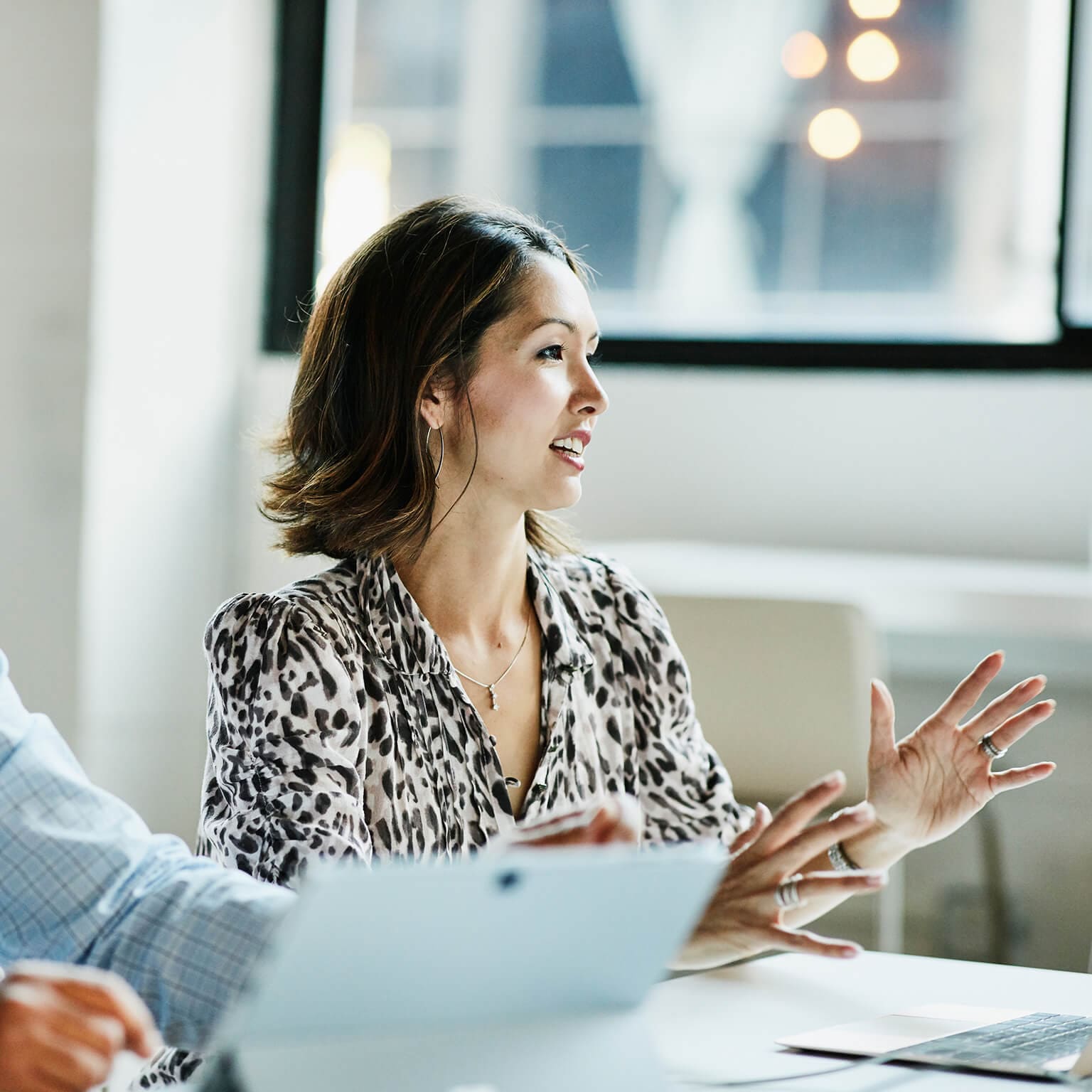woman speaking sitting at conference table