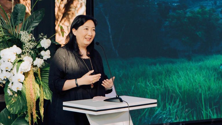 Phillia Wibowo speaking at podium