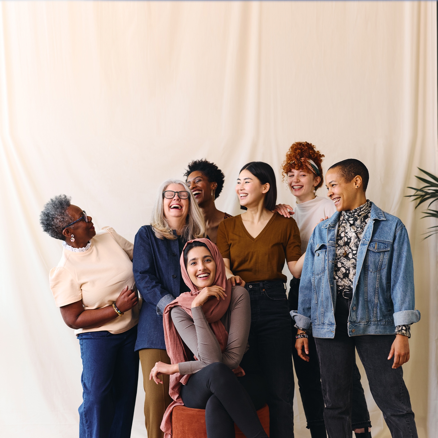 Portrait of cheerful mixed age range multi ethnic women celebrating International Women's Day - stock photo