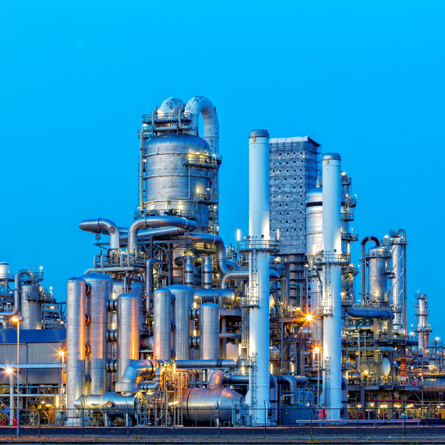 Petrochemical plant illuminated at dusk