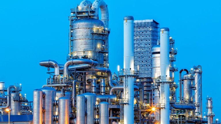 Petrochemical plant illuminated at dusk