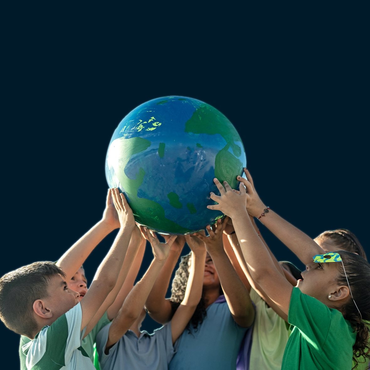 Children holding a planet outdoors - stock photo