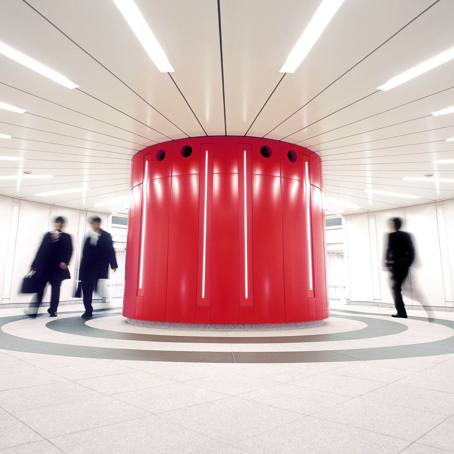 Businessmen crossing an underground underpass at a business district in Tokyo, Japan.  - stock photo