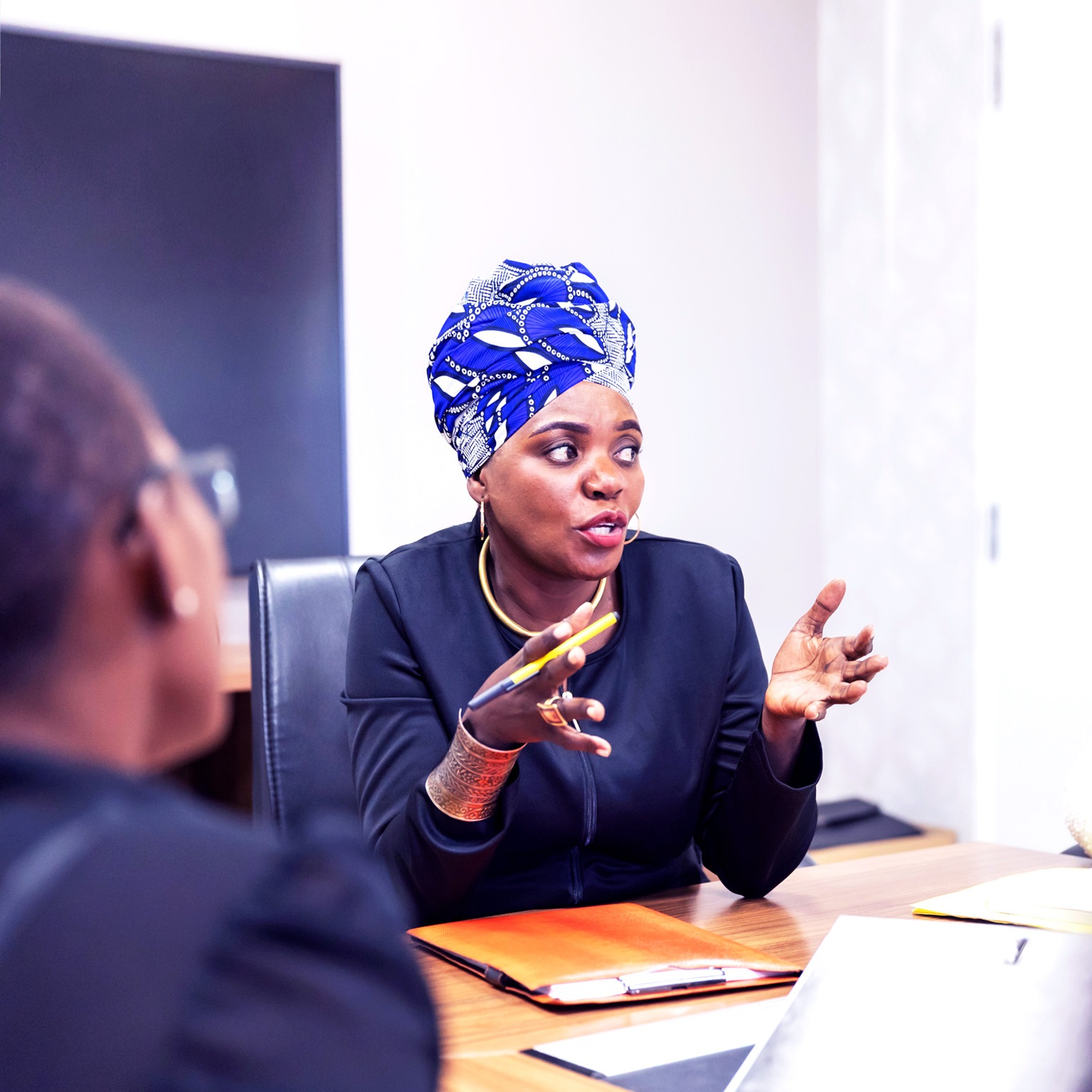 Successful African businesswoman chairing a meeting in a boardroom