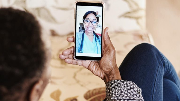 Person sitting on couch while video calling a girl on their smartphone
