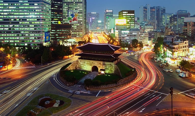 Elevated view of Namdaemun Gate and traffic at dusk in Seoul, South Korea. - stock photo
