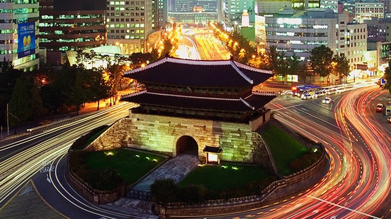 Elevated view of Namdaemun Gate and traffic at dusk in Seoul, South Korea. - stock photo