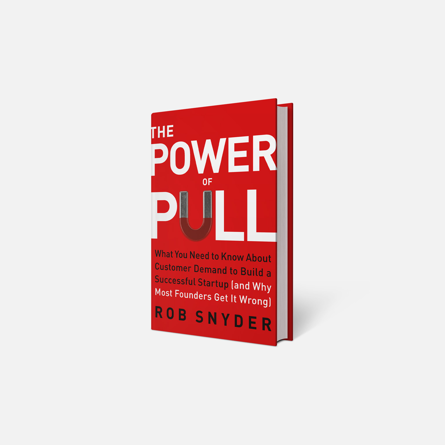 A red book titled “The Power of Pull” by Rob Snyder is shown standing upright against a plain light background. The cover features bold white typography and a magnet motif in place of the 'U' in Pull.