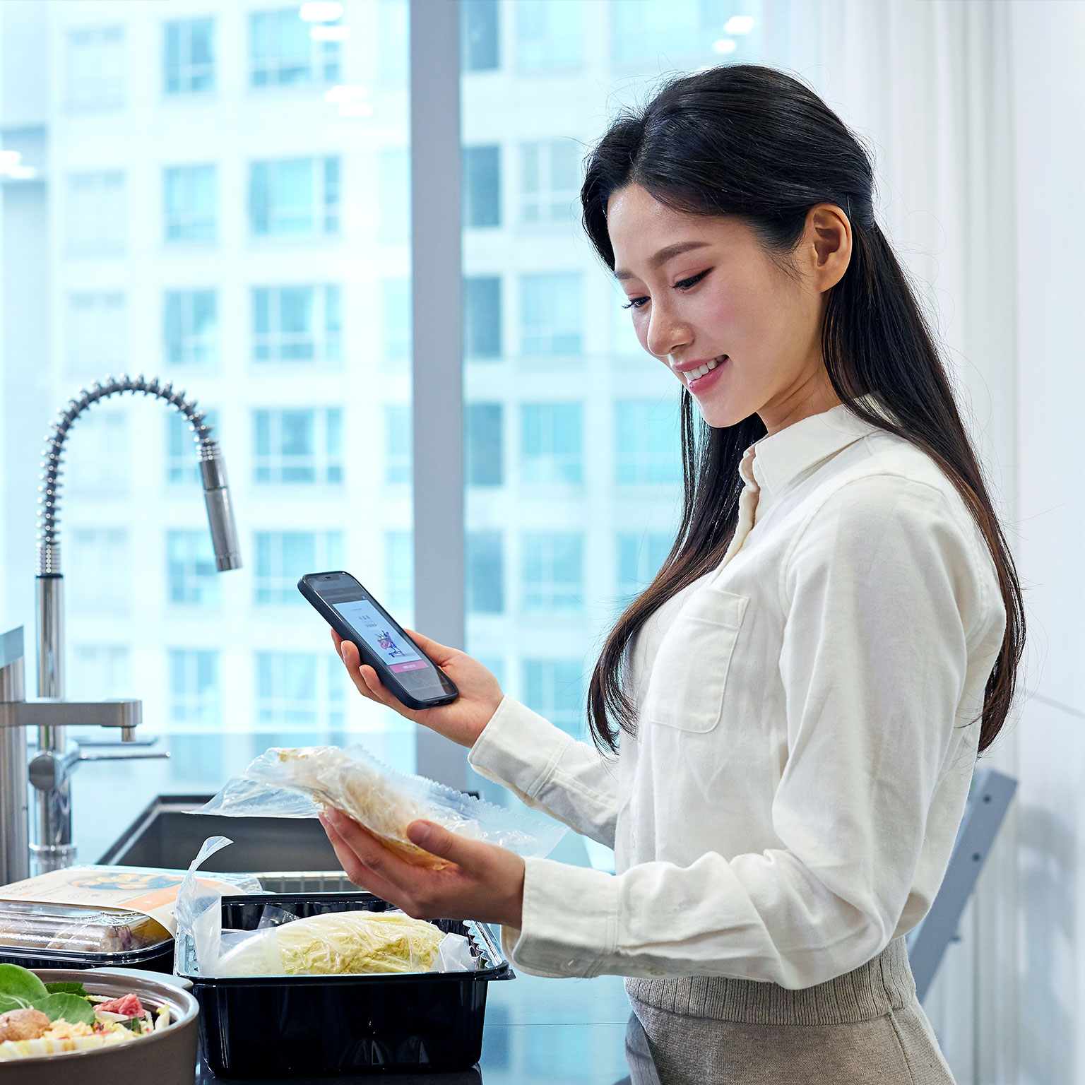 Smiling Woman with Meal Kit - stock photo