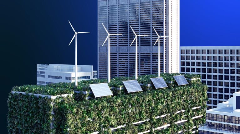 Image of high-rises in a cityscape focused on a sustainable building with solar panels, wind turbines, and a green roof.