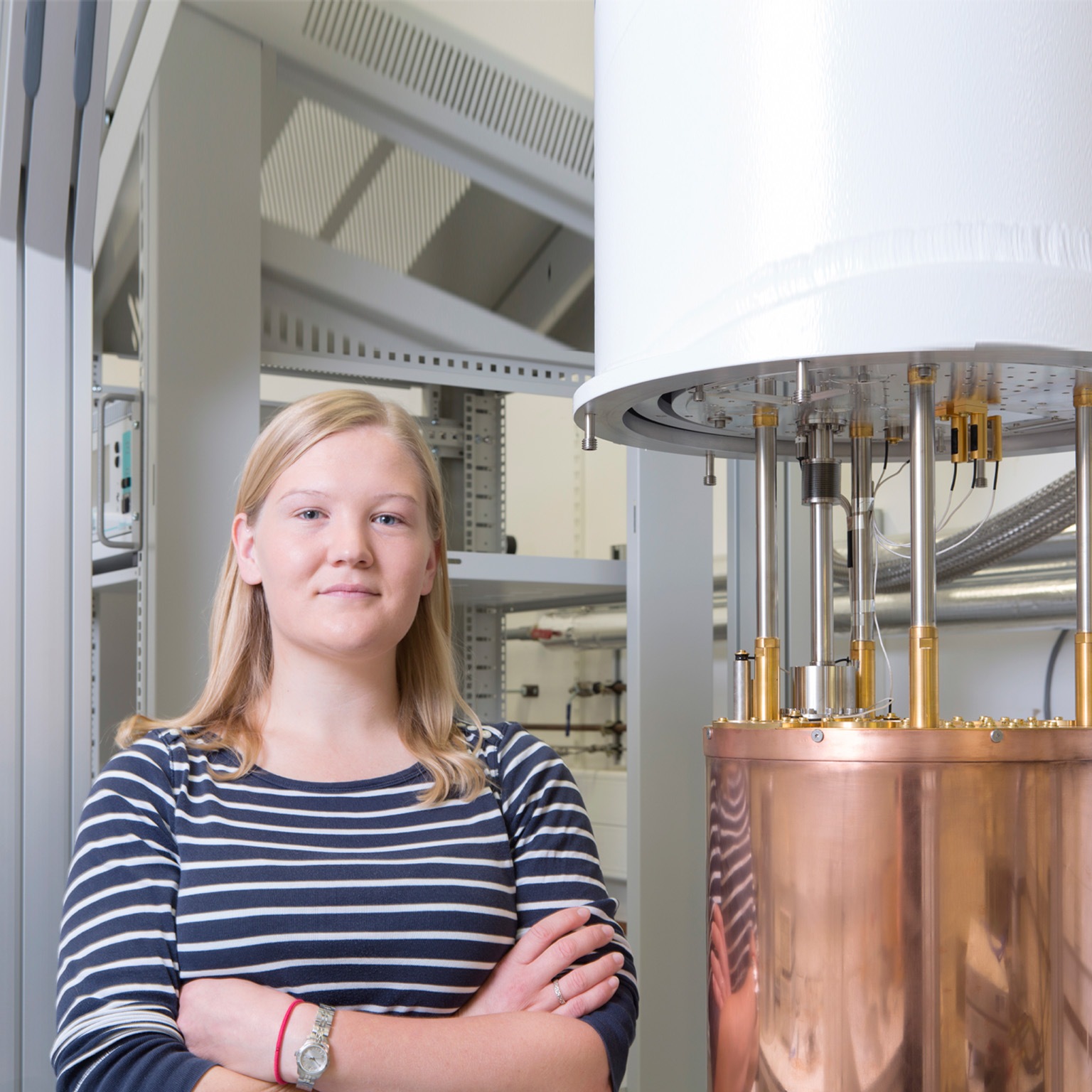 Portrait of a female physicist next to a dilution - stock photo
