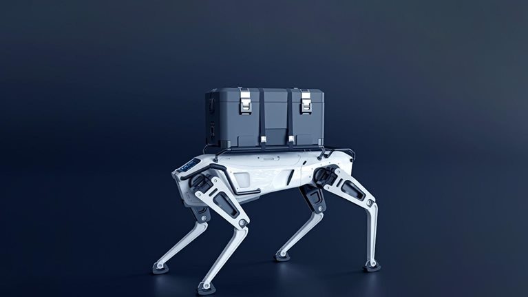 A robotic dog with a sleek white design and black detailing has a large gray container strapped to its back.