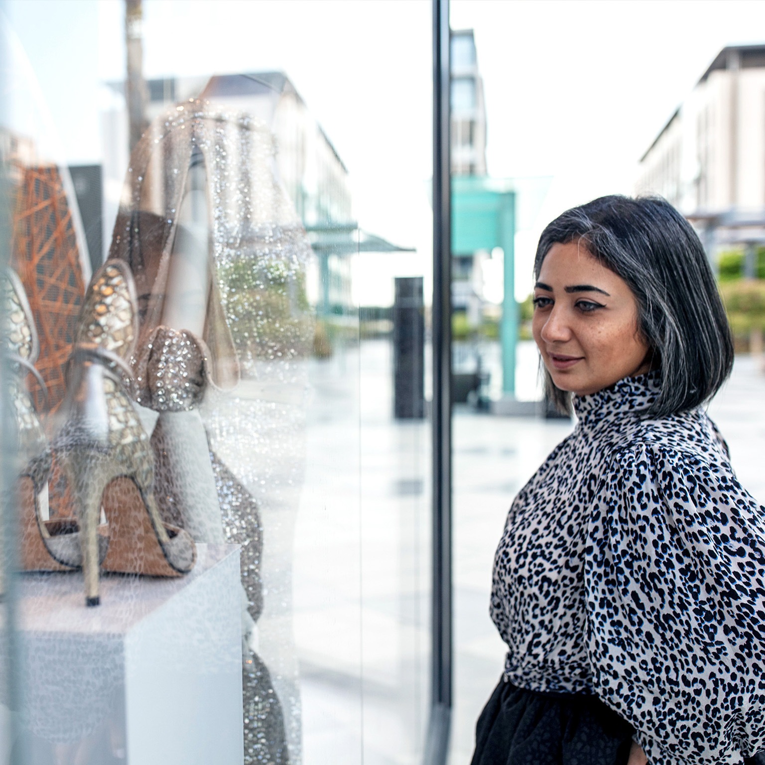 Middle Eastern woman window shopping