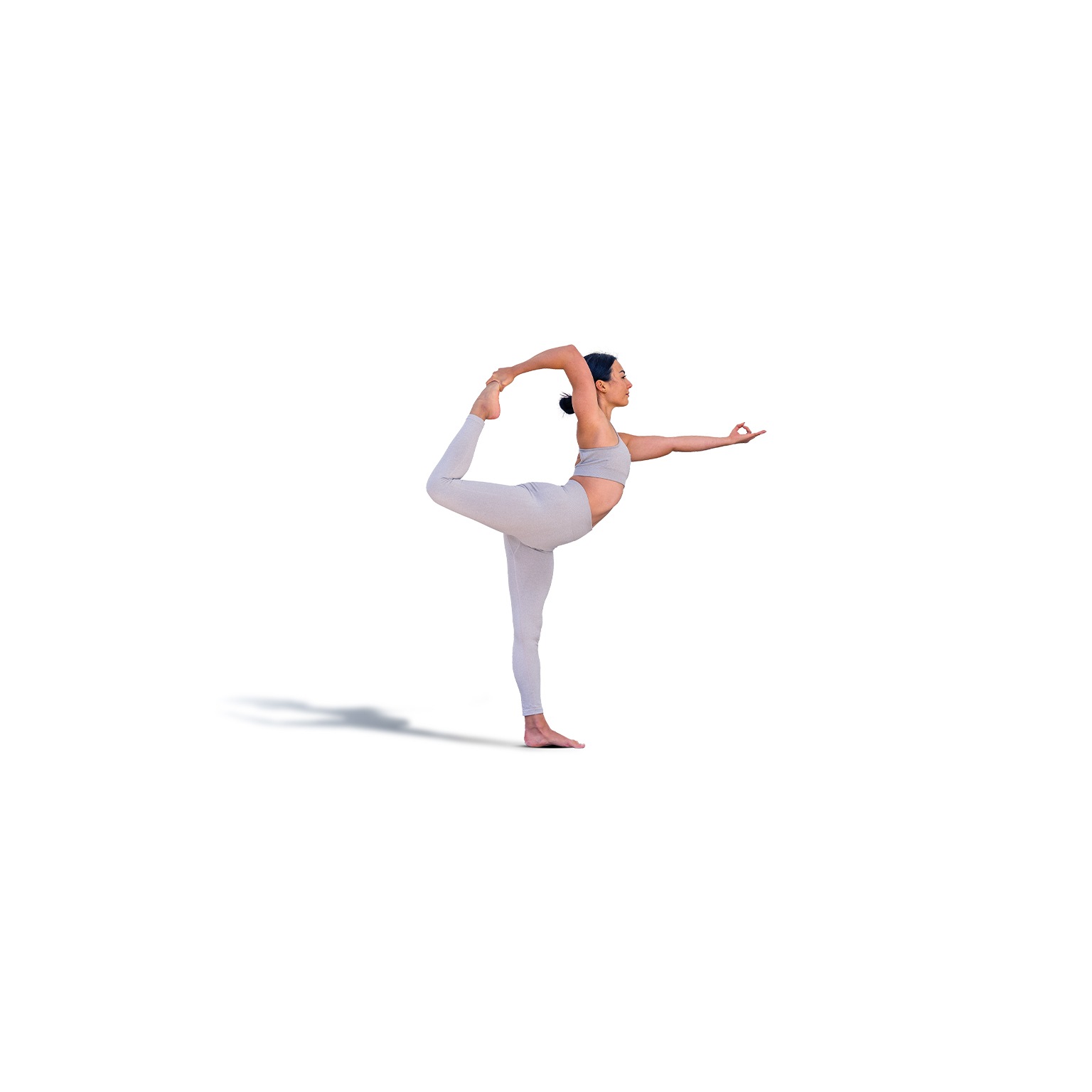 Brunette woman in sportswear doing the Natarajasana pose or dancer's pose