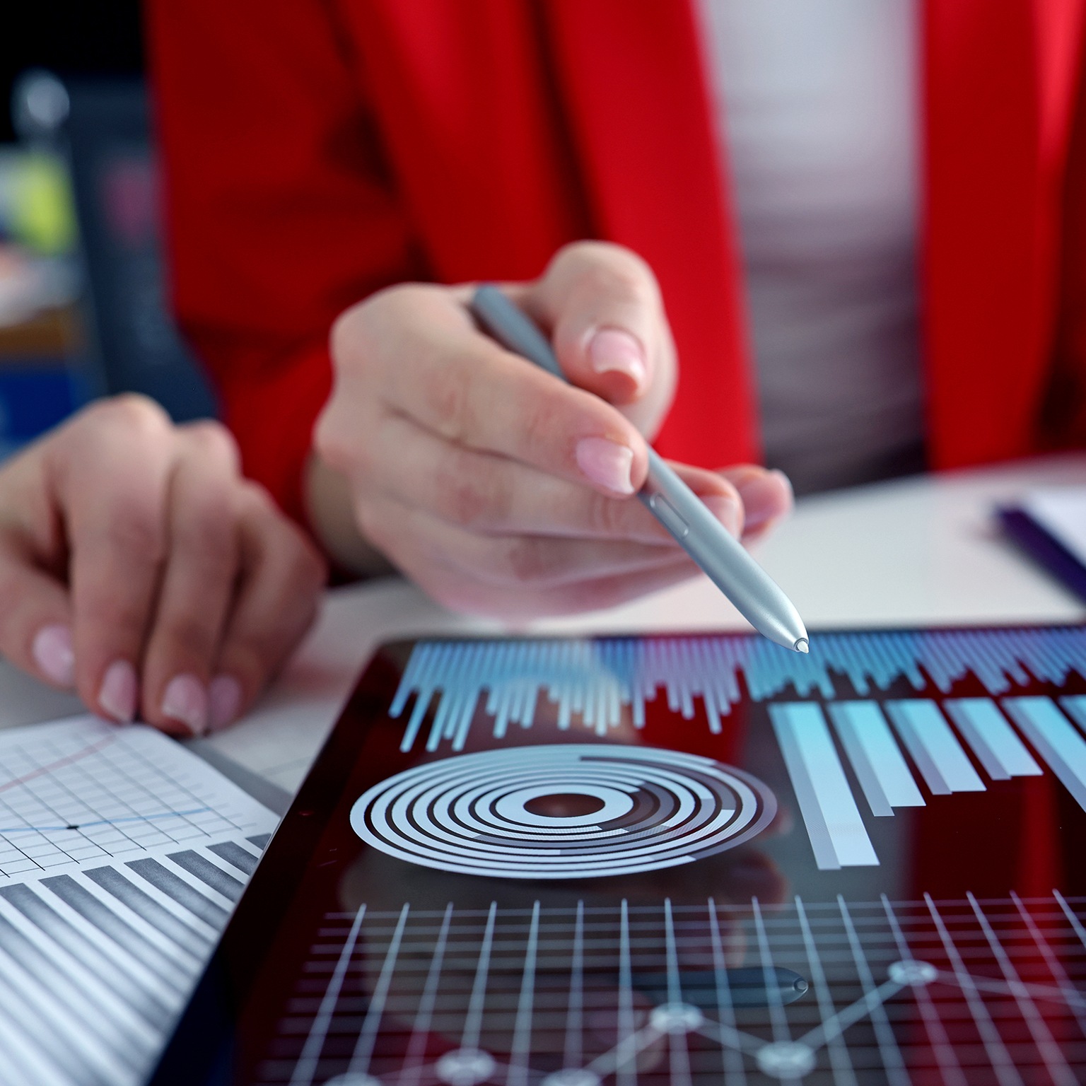 Closeup of business women studying charts and diagrams on a digital tablet