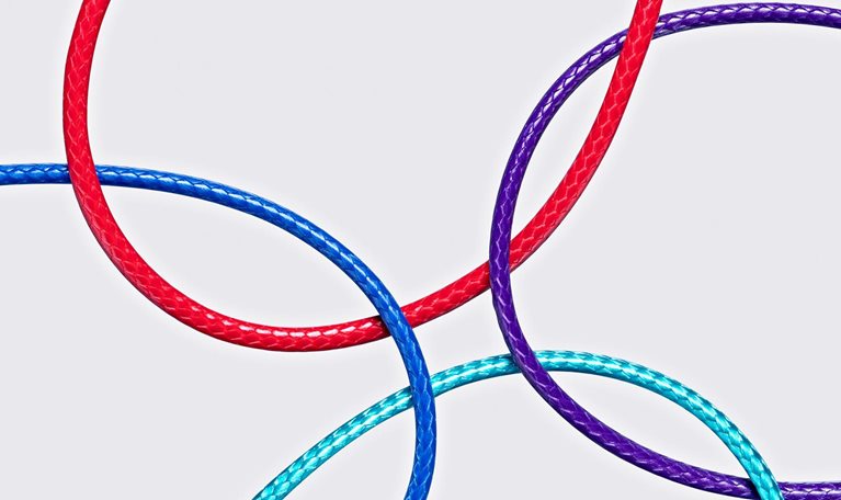 Four different color ropes crossed and converged together