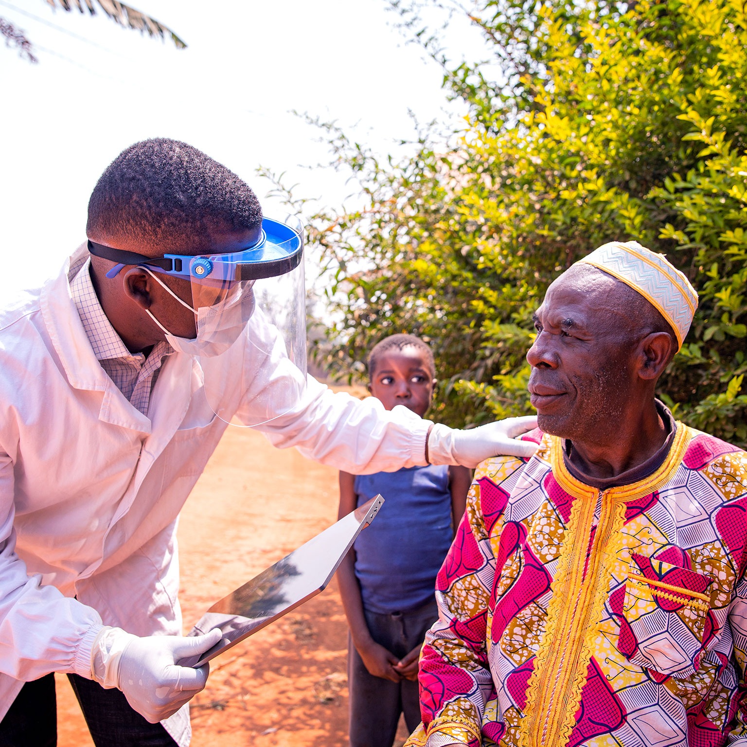 African doctor conversing with an elderly patient during a medical examination