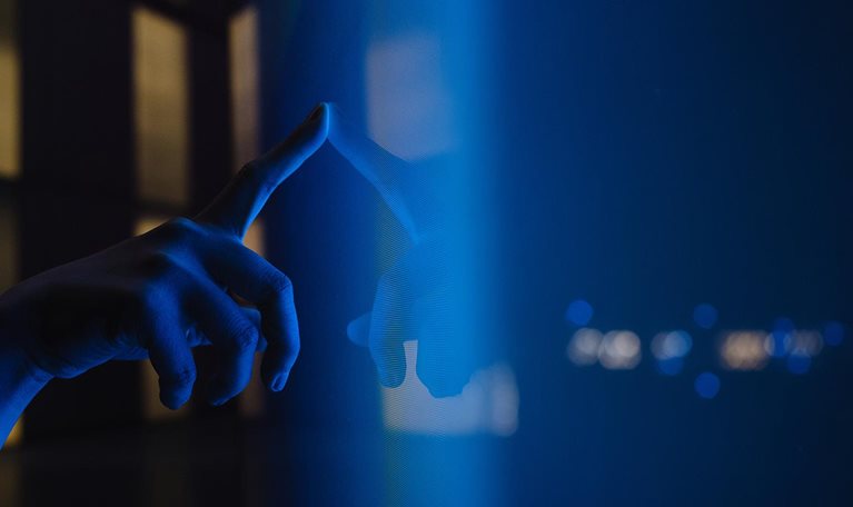 Close up view of woman hand using interactive touchscreen display of electronic kiosk