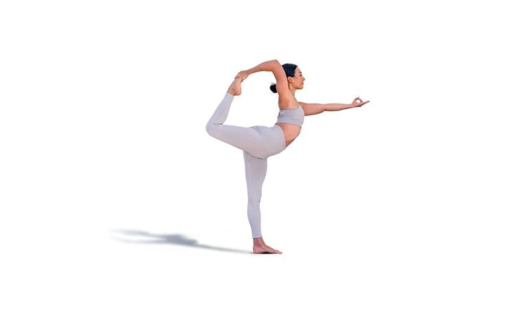 Brunette woman in sportswear doing the Natarajasana pose or dancer's pose