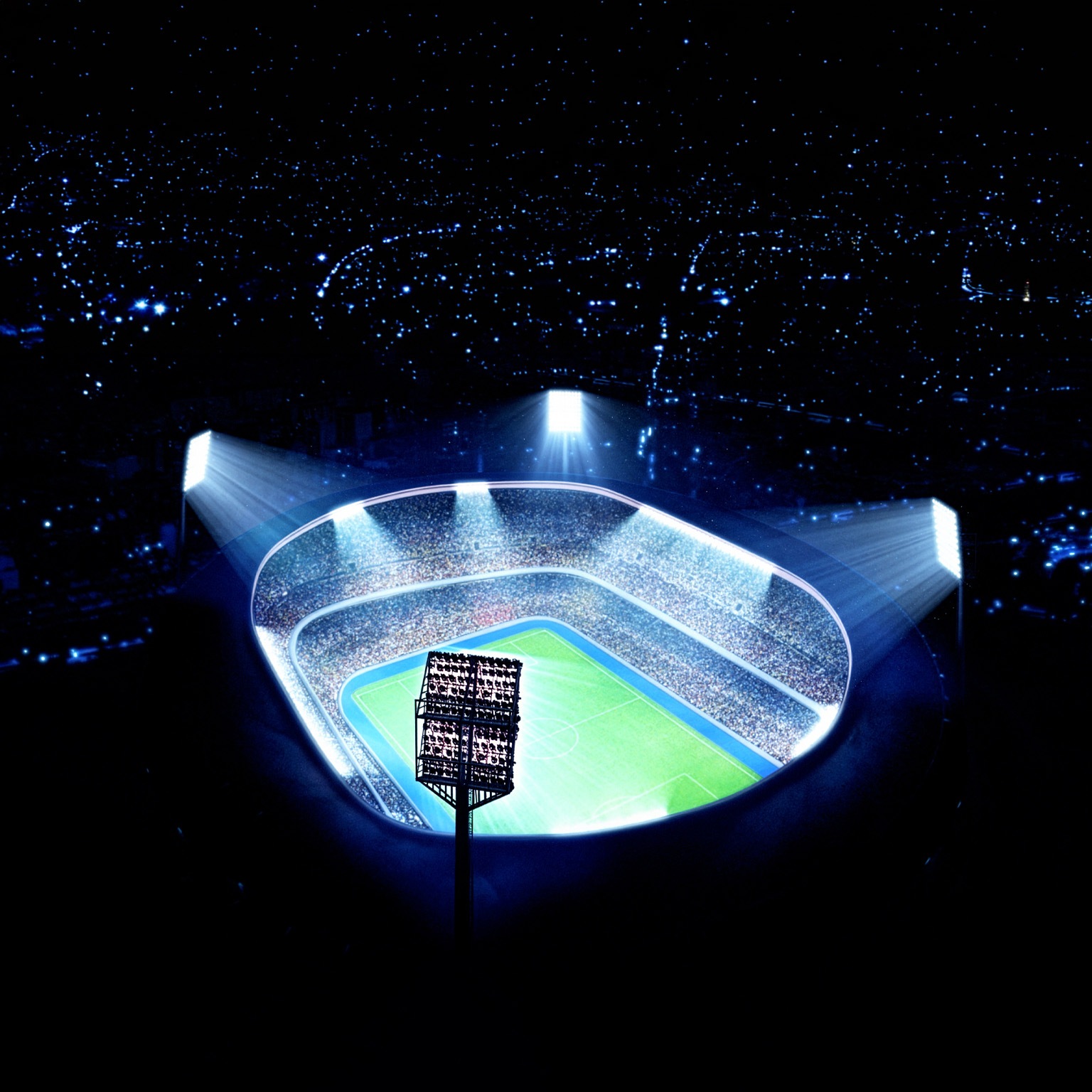 A brightly lit, modern soccer stadium packed with spectators is shown from an aerial perspective, with powerful floodlights illuminating the field at night. The scene emphasizes scale and energy, highlighting a vibrant sports arena surrounded by darkness.