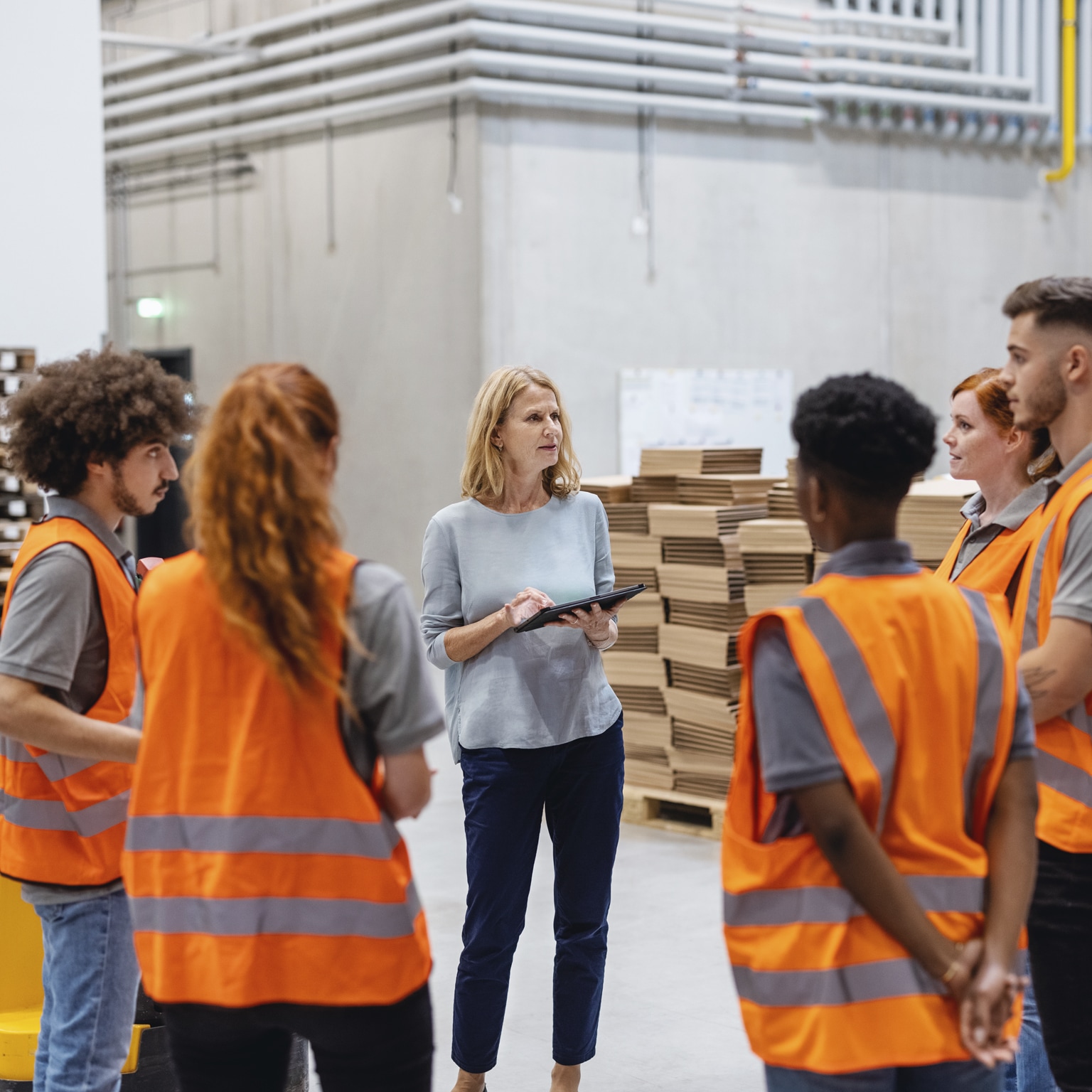 Warehouse manager talking with a team of workers