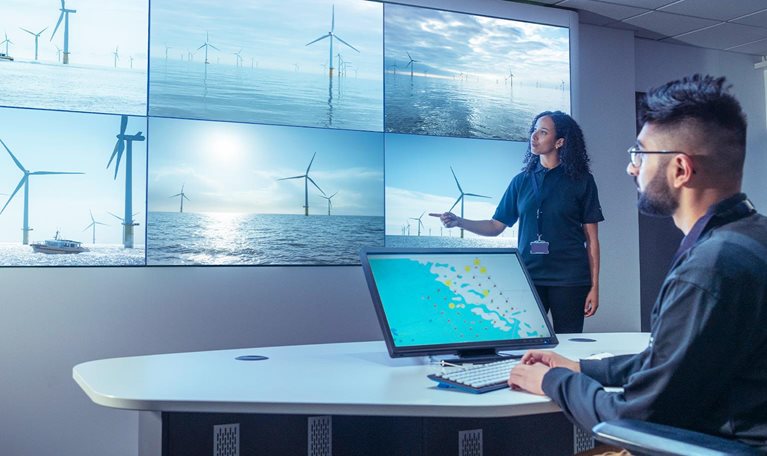 UK, York, Male and female operators in offshore wind farm control room - stock photo