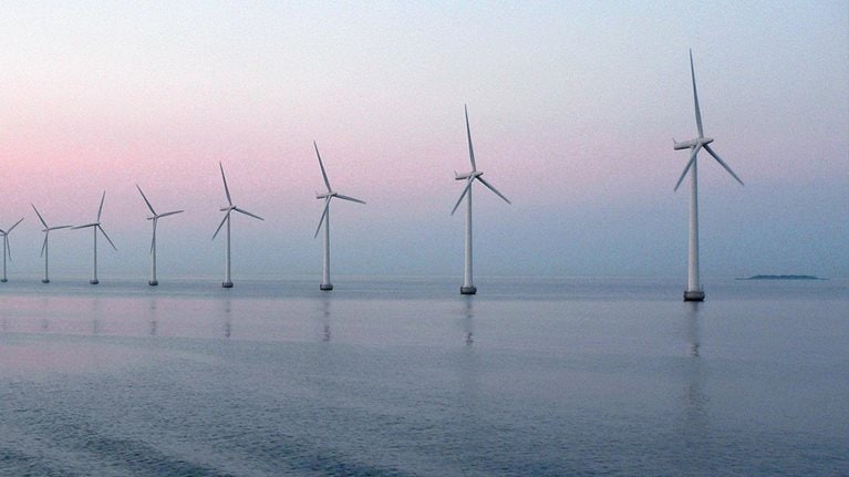 Wind farm at sunset in sea