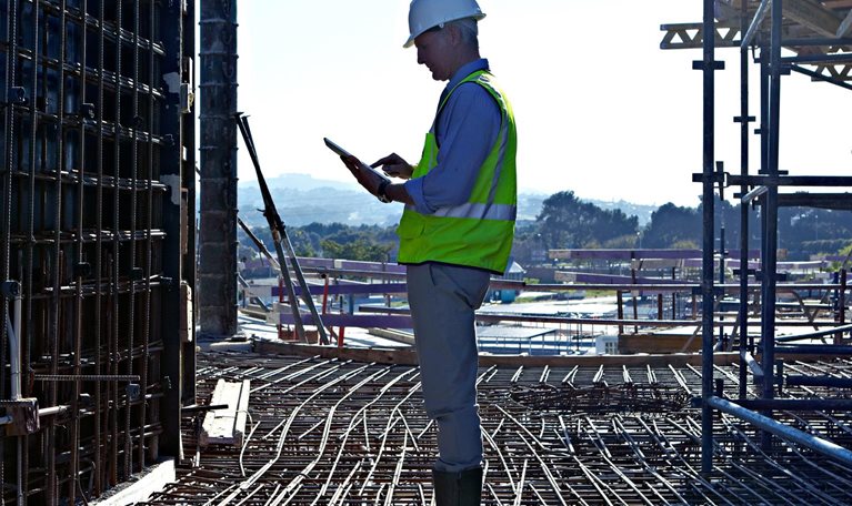 Worker man standing at a construction site