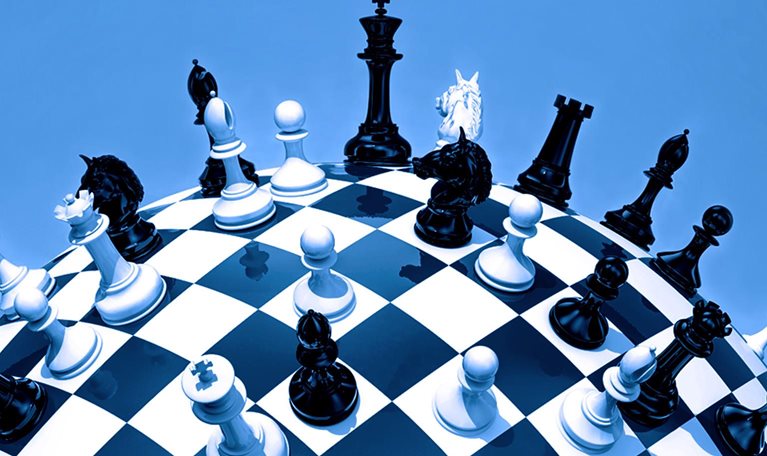 A globe styled as a chessboard, with chess pieces scattered across its surface.