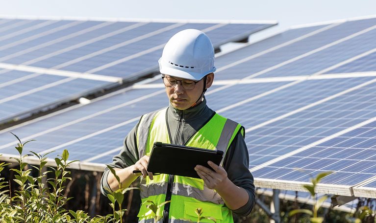Engineer working with digital tablet in solar power station