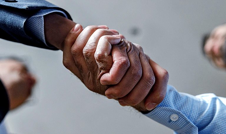 Close up of two businessmen shaking hands.