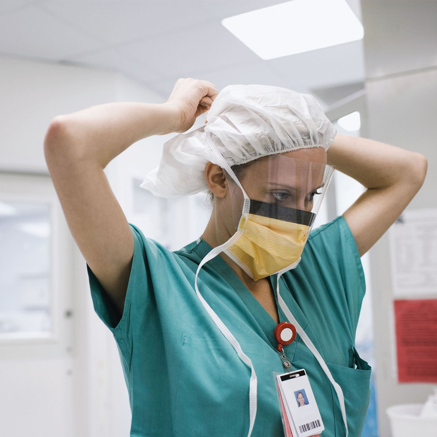 Surgeon tying surgical mask