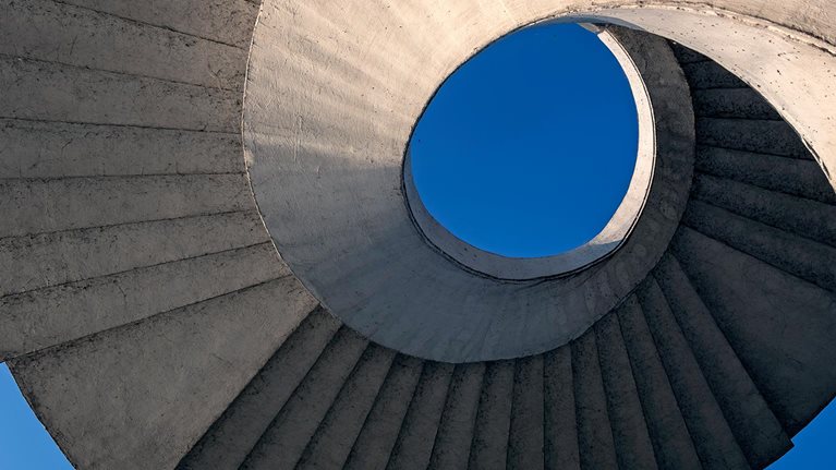 Abstract view of a circular concrete stairway under the Gdanski Bridge in Warsaw, Poland