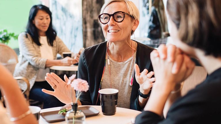 Business people discussing at table in cafe - stock photo