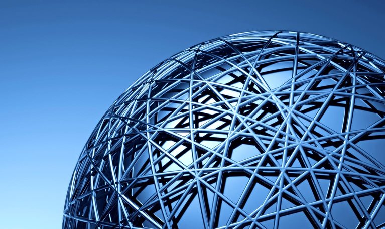 A close-up view of a large metallic spherical structure made of interwoven beams, creating a complex geometric pattern.