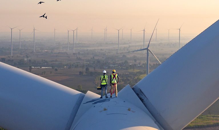 Two rope access technicians working on higher wind turbine blades