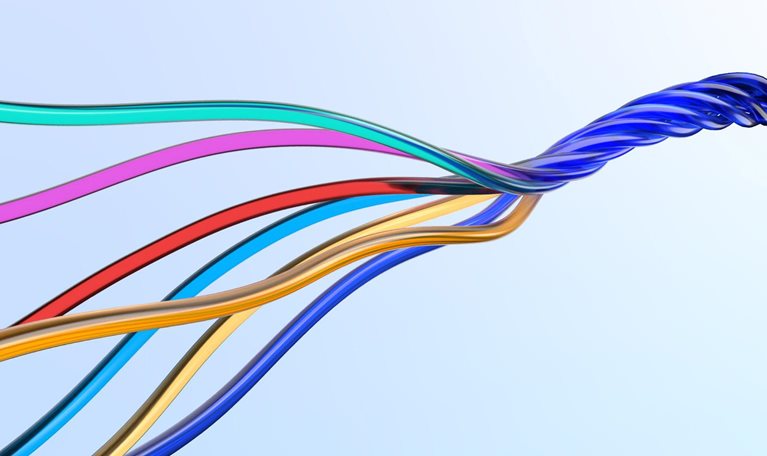 Image of multicolored wires twisting together.
