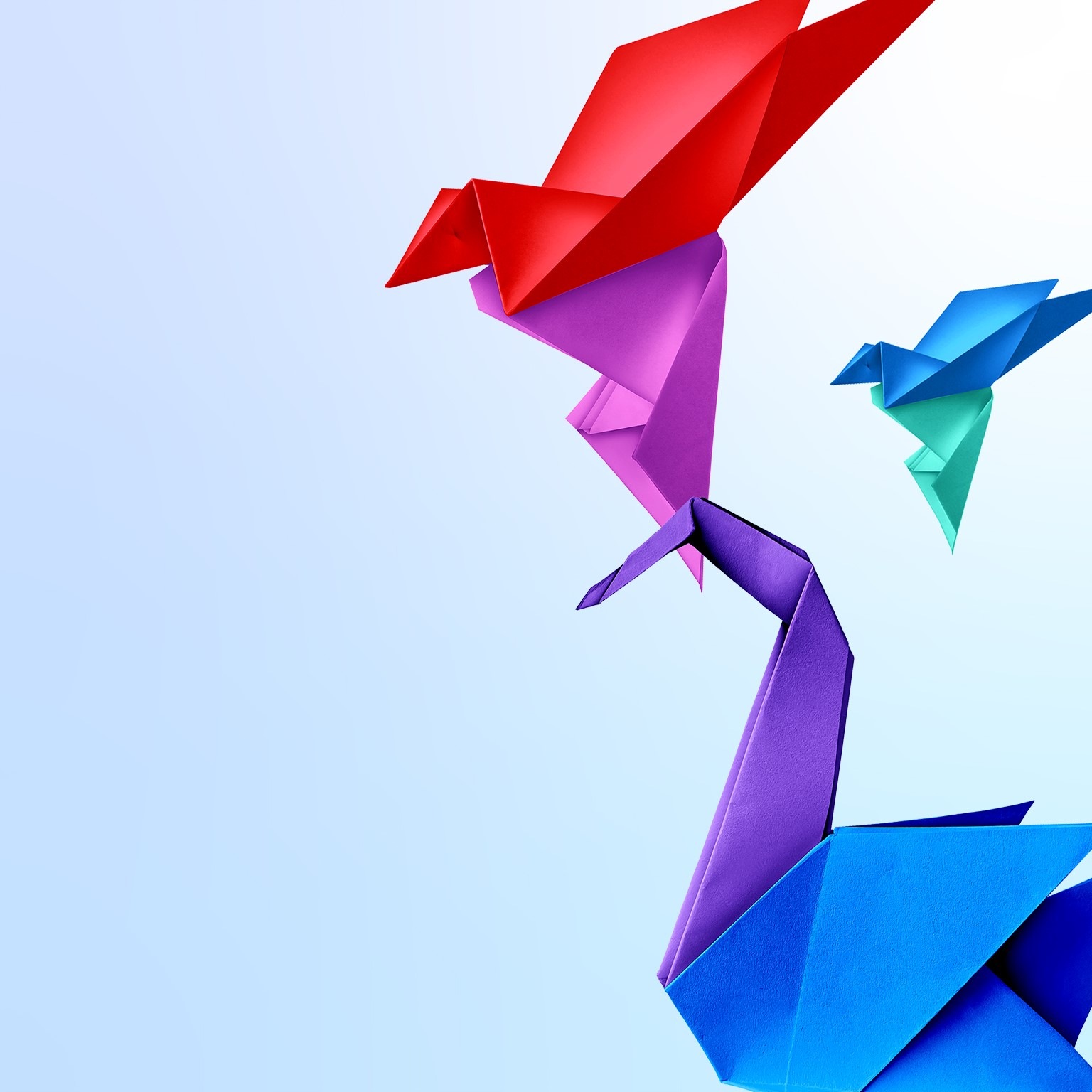 Three origami birds on a light blue background