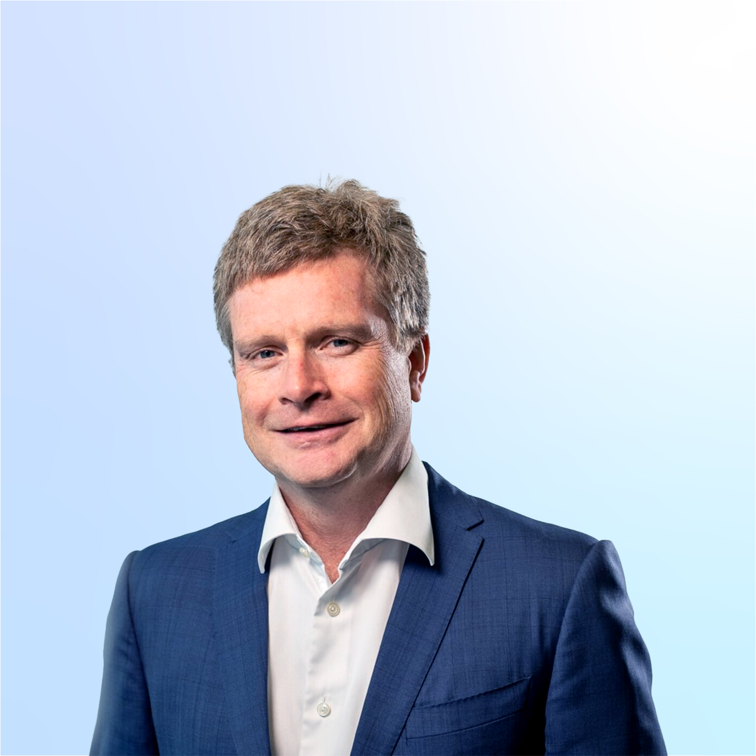 Sean Doyle in a suit against a light blue background