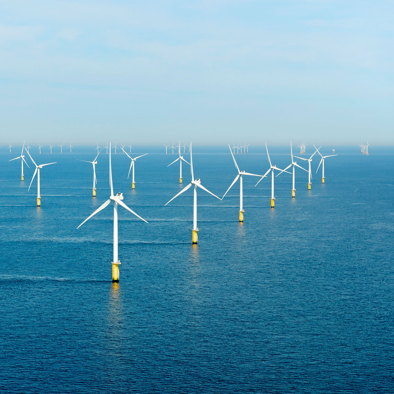 Windmills standing in a waterbody.