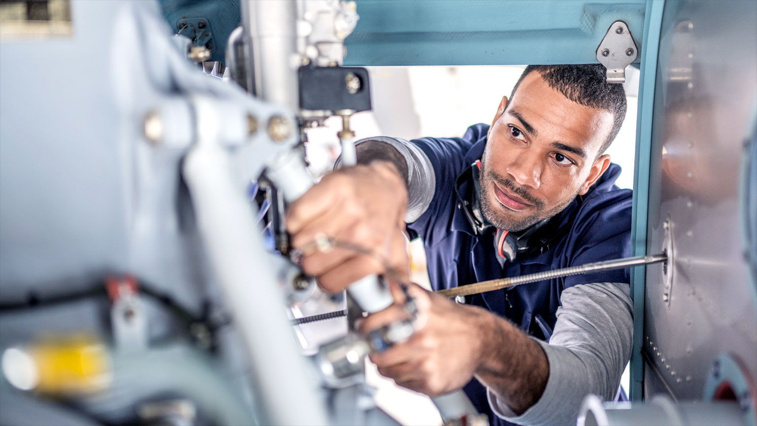 Technician works inside machinery
