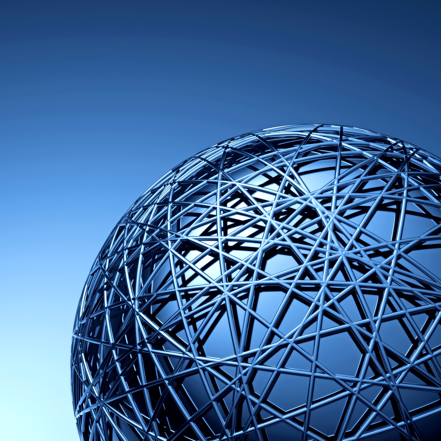 A close-up view of a large metallic spherical structure made of interwoven beams, creating a complex geometric pattern. 