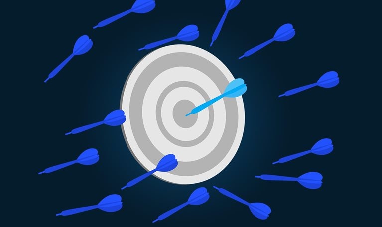 Illustration of darts, stuck in the wall, with one dart hitting the bullseye.