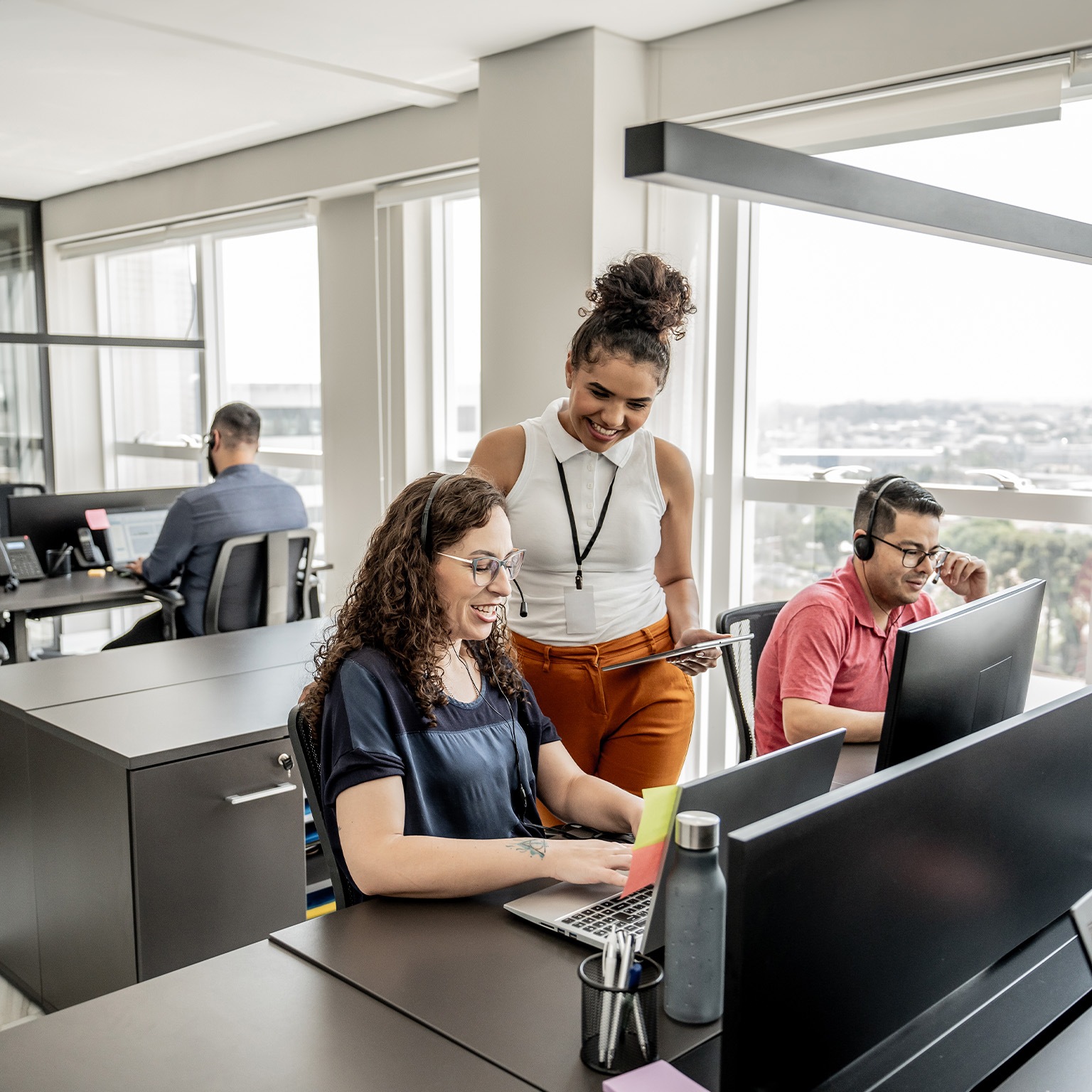 Call center manager instructing employees - stock photo