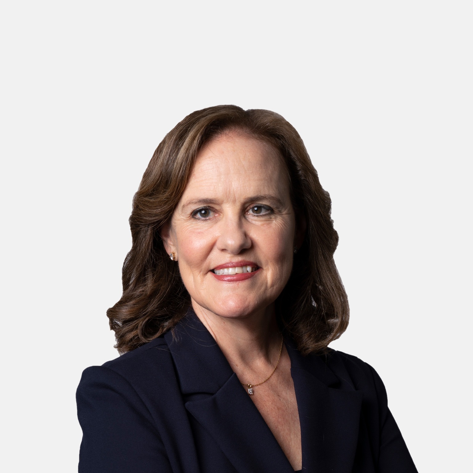 Michèle Flournoy with a light smile and a navy blazer.