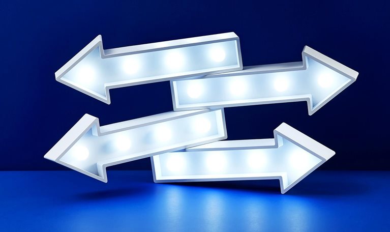 Image of four stacked lit up arrows pointing in different directions.