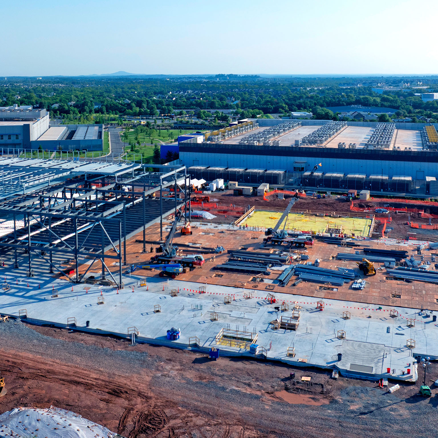 Aerial view of a data center being constructed among existing centers
